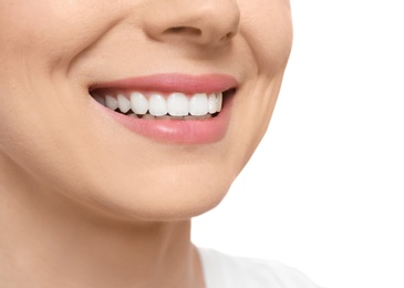 Young woman with beautiful smile on white background, closeup. Teeth whitening