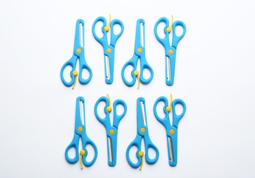 Set of training scissors on white background, top view