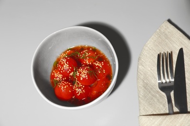 Tasty soup with blanched tomatoes on light table, above view