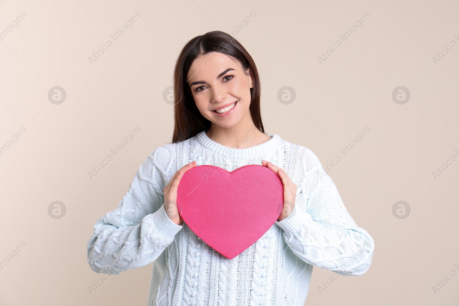 Photo of Portrait of young woman with decorative heart on color background