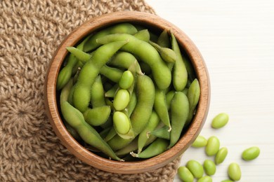 Photo of Green edamame beans on white wooden table, flat lay