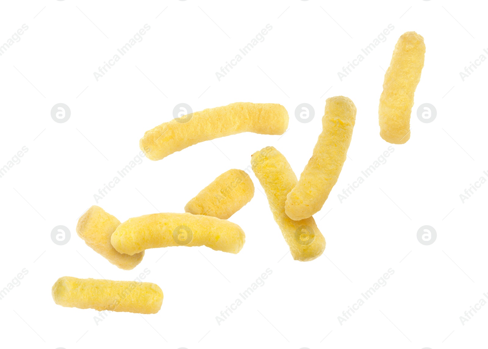 Image of Many tasty corn sticks falling on white background