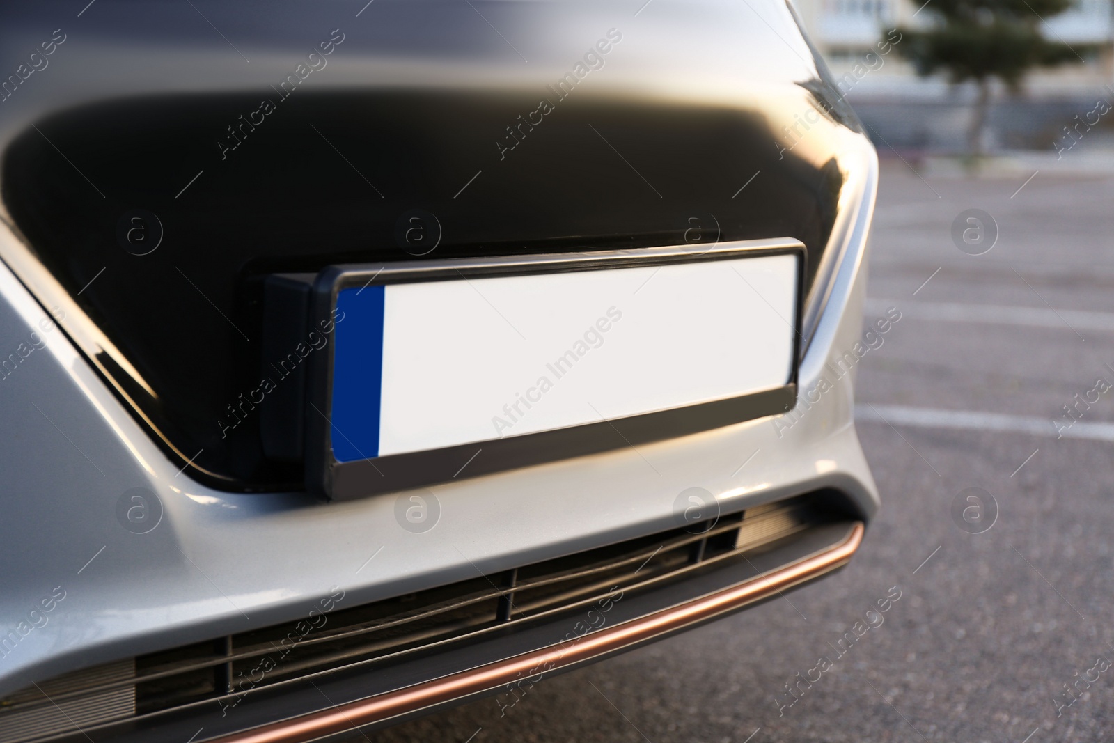 Photo of Vehicle registration plate on car outdoors, closeup