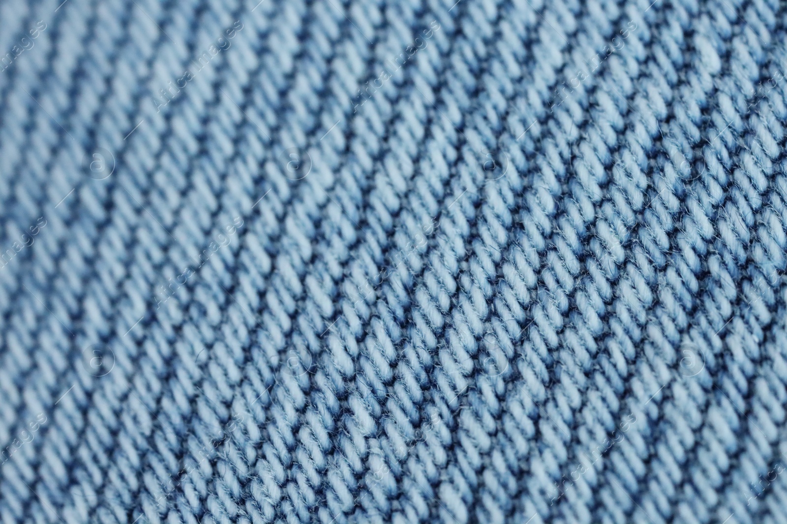 Photo of Light blue denim as background, closeup view