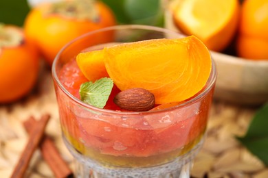 Photo of Delicious dessert with persimmon and chia seeds, closeup