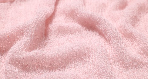 Photo of Texture of soft pink crumpled fabric as background, closeup