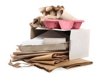 Stack of different waste paper on white background