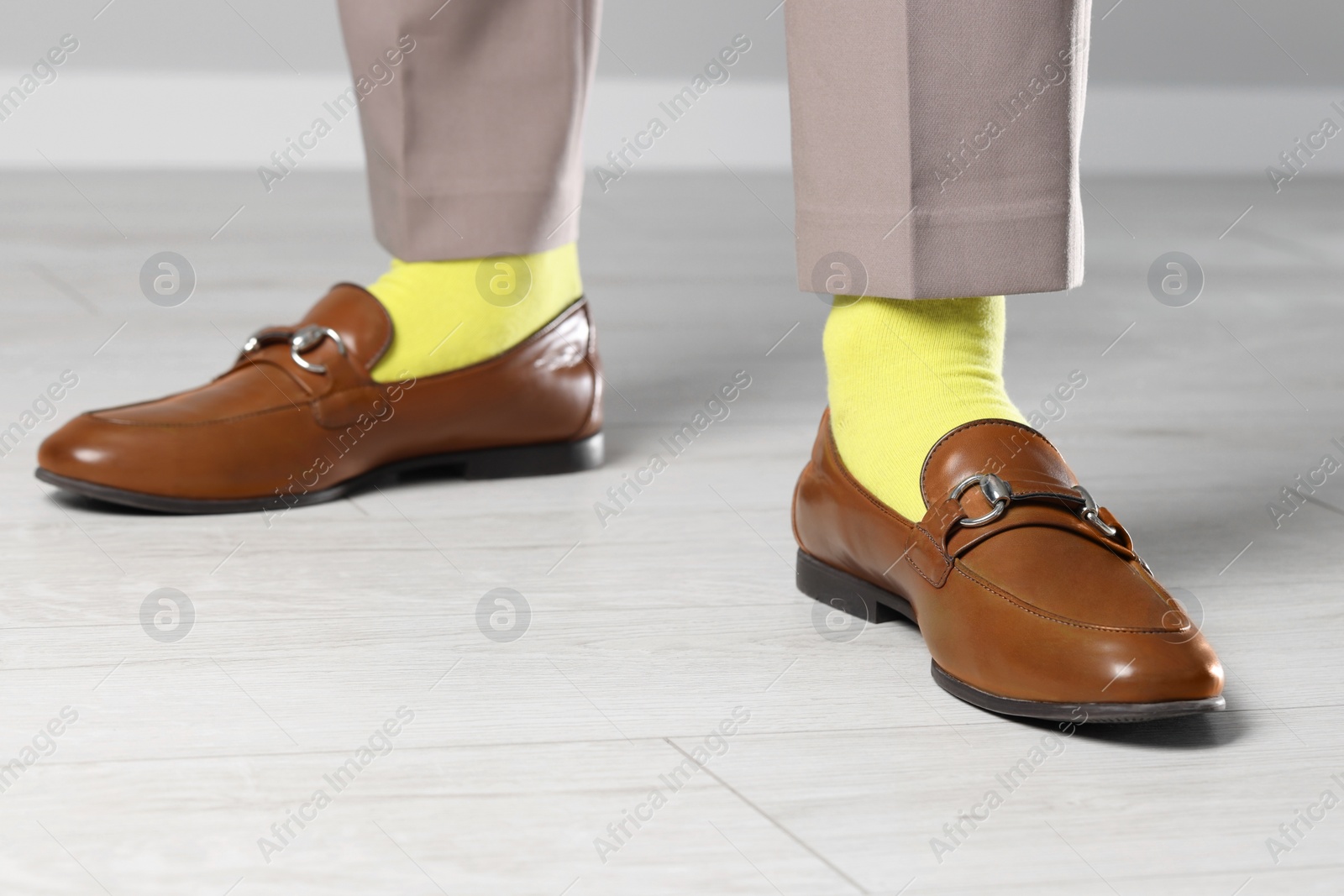 Photo of Man wearing stylish shoes and yellow socks indoors, closeup