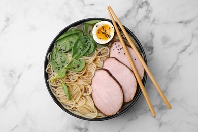 Photo of Delicious ramen with meat on white marble table, top view. Noodle soup