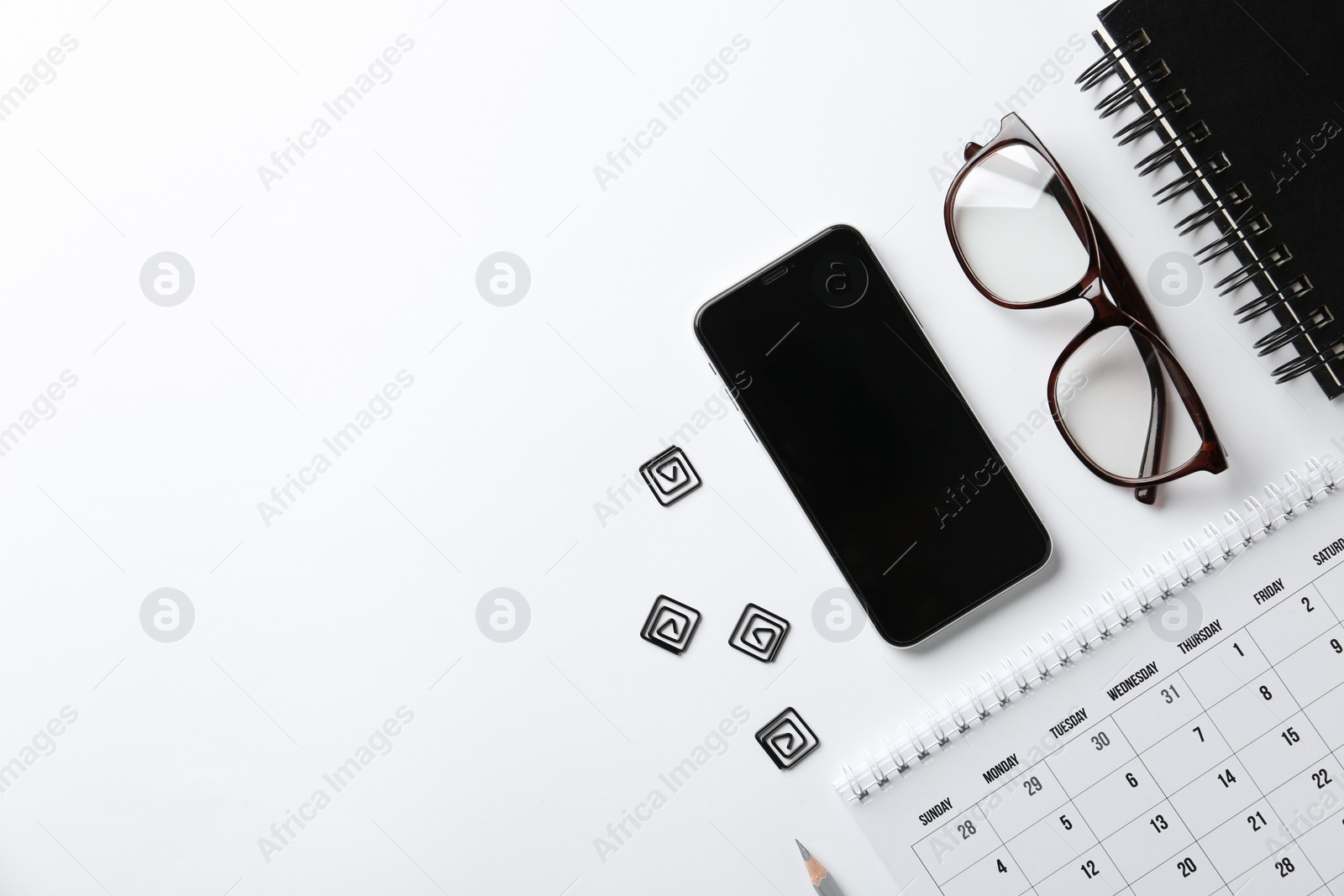 Photo of Composition with calendar, glasses and mobile phone on white background, top view