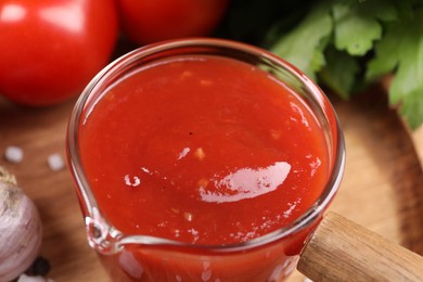 Photo of Delicious ketchup on table, closeup. Tomato sauce