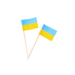 Photo of Small paper flags of Ukraine on white background, top view