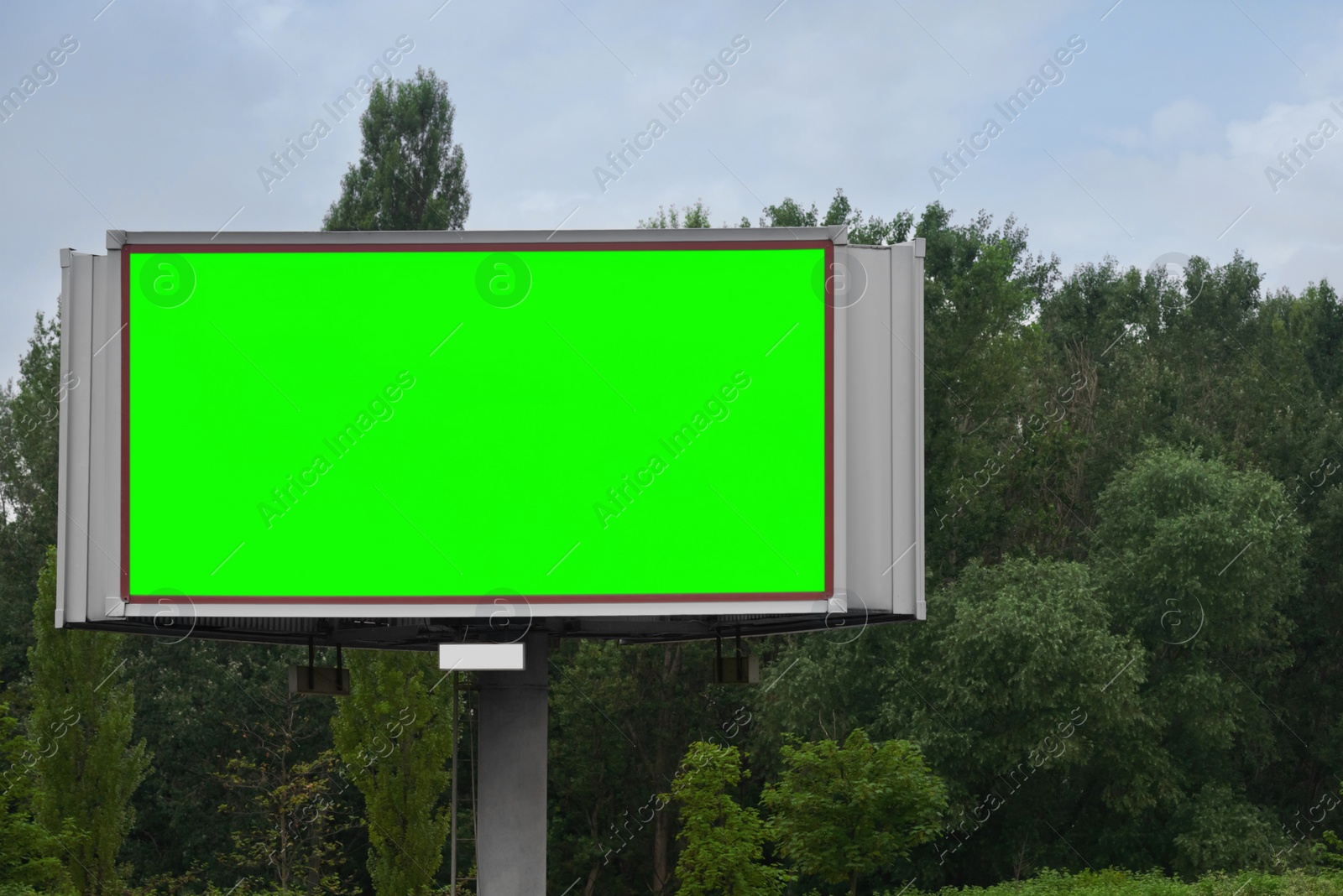 Image of Chroma key compositing. Big empty billboard with green screen outdoors. Mockup for design