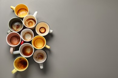Photo of Many dirty cups after drinking coffee on grey table, flat lay. Space for text