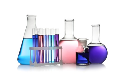 Photo of Set of different lab glassware with color liquid isolated on white