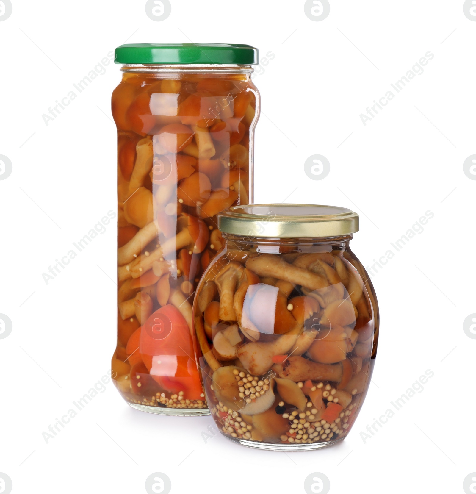 Photo of Jars with marinated mushrooms on white background