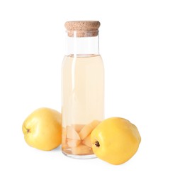 Photo of Tasty quince drink in glass carafe and fresh fruits isolated on white