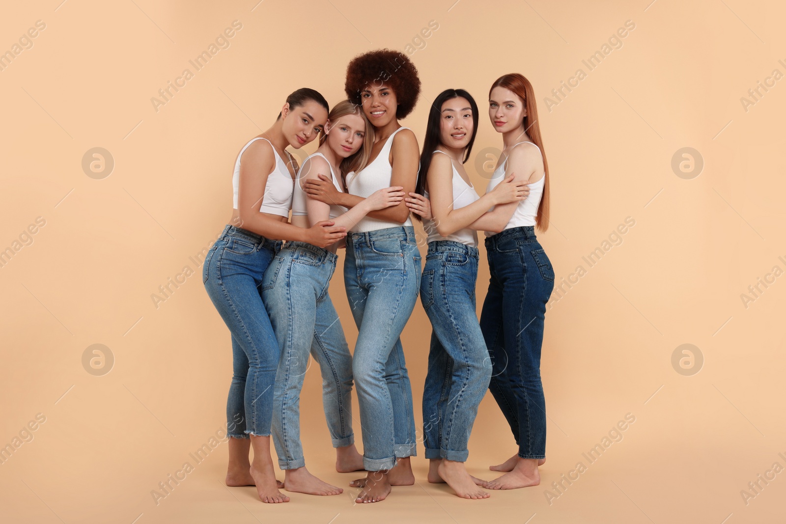 Photo of Group of beautiful young women on beige background