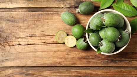 Image of Flat lay composition with fresh green feijoa fruits on wooden table, space for text. Banner design