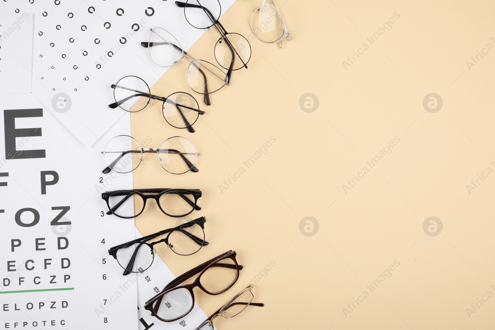 Photo of Vision test chart and glasses on beige background, flat lay. Space for text