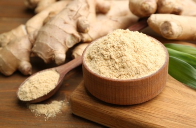 Dry and fresh ginger on wooden table, closeup