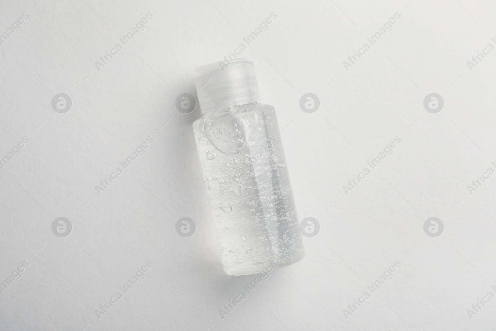 Photo of Bottle of cosmetic gel on white background, top view