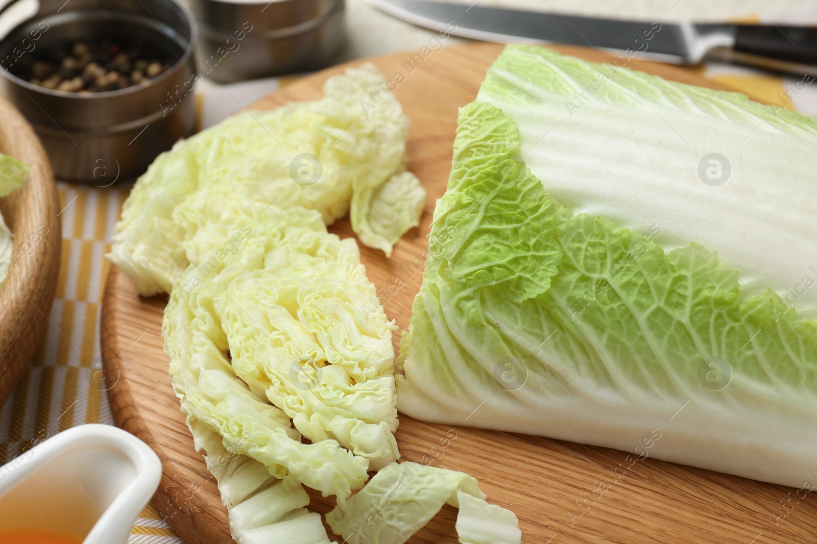 Photo of Cut fresh Chinese cabbage on table, closeup