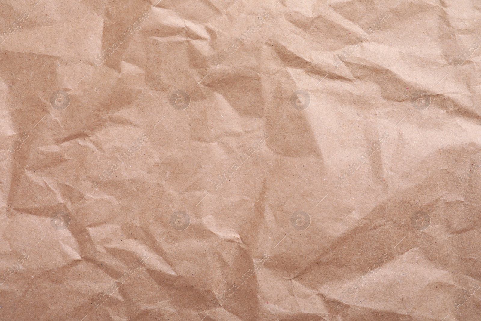 Photo of Texture of wrinkled kraft paper bag as background, closeup