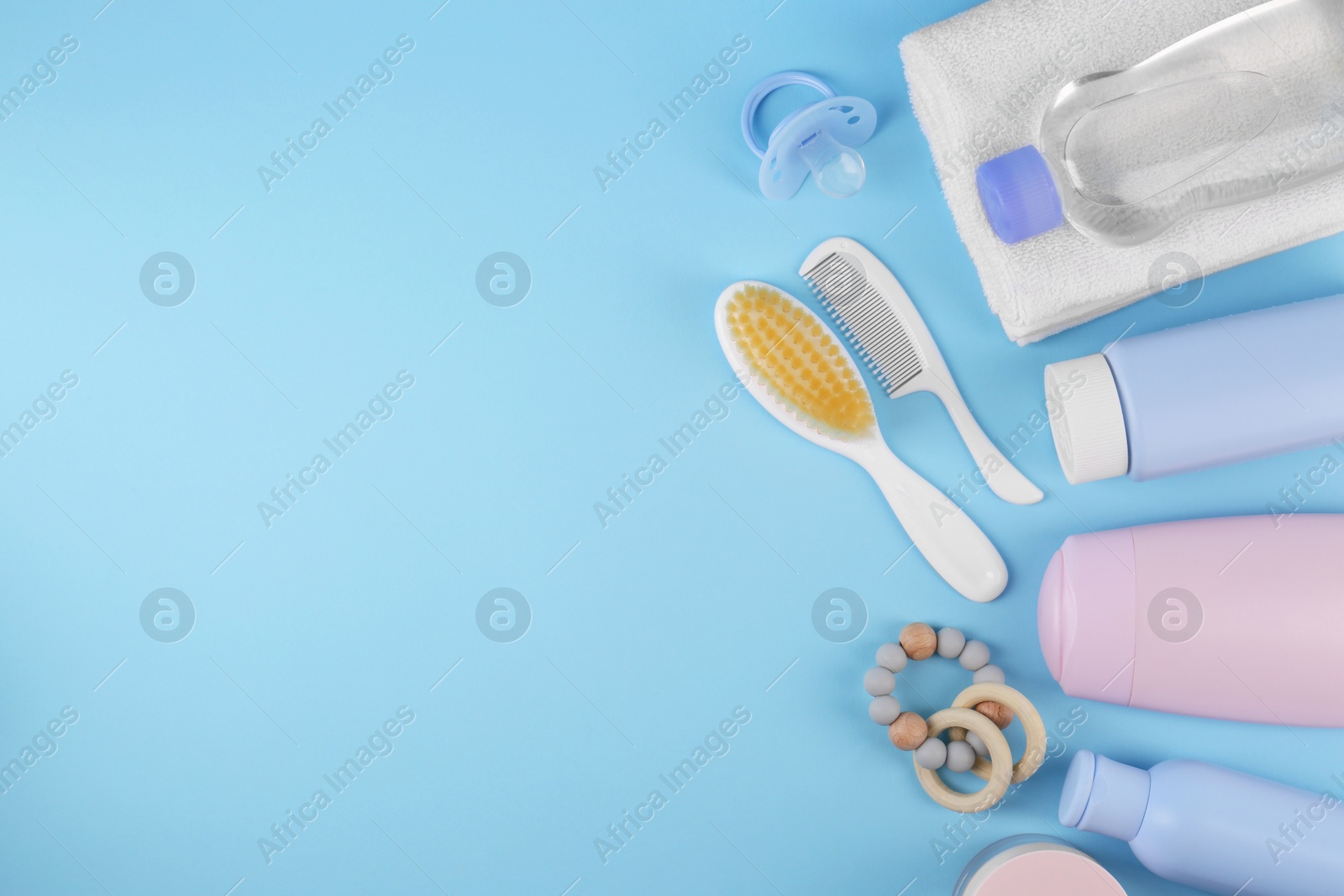 Photo of Flat lay composition with baby care products and accessories on light blue background, space for text