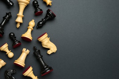 Many different chess pieces on black background, flat lay. Space for text