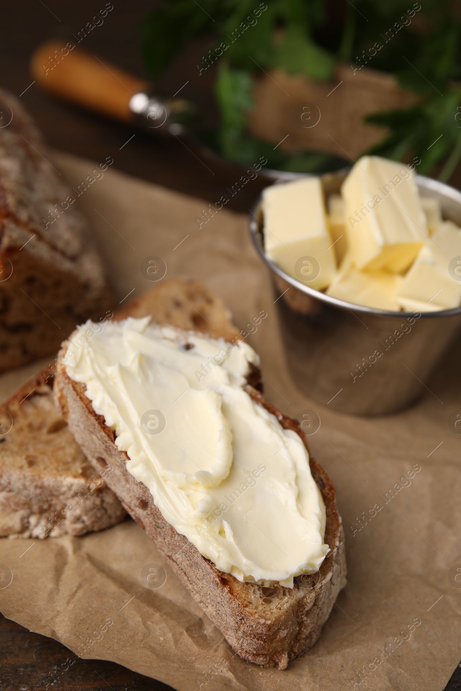 Photo of Tasty bread with butter on table, closeup