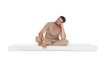 Man sitting on soft mattress against white background