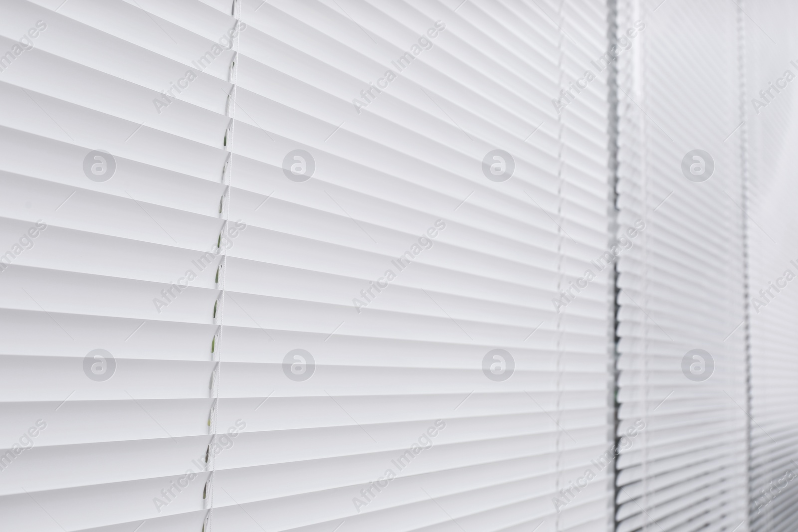 Photo of Window with closed white horizontal blinds as background