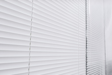 Photo of Window with closed white horizontal blinds as background
