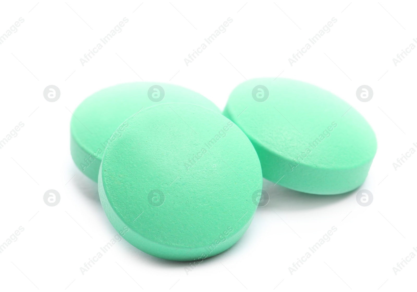 Photo of Pile of color pills on white background