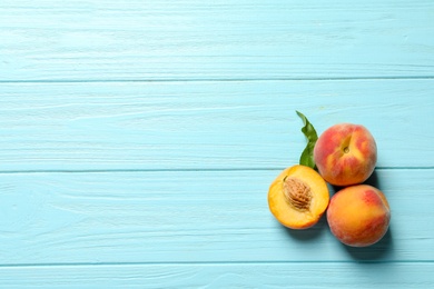 Photo of Fresh sweet peaches on wooden table, top view