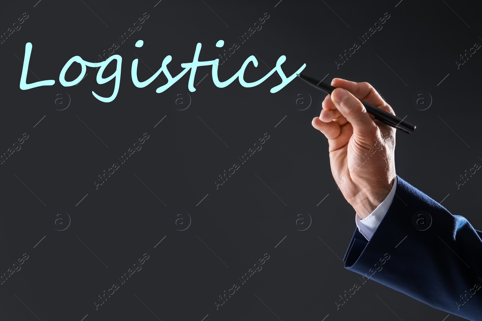 Image of Businessman pointing at word LOGISTICS on virtual screen against dark background, closeup 