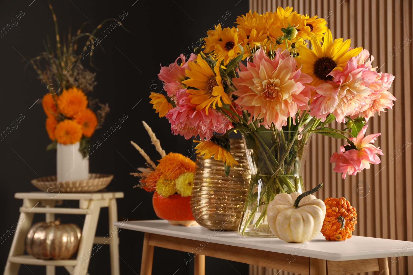 Photo of Room decorated with pumpkins and bright flowers, space for text. Autumn vibes