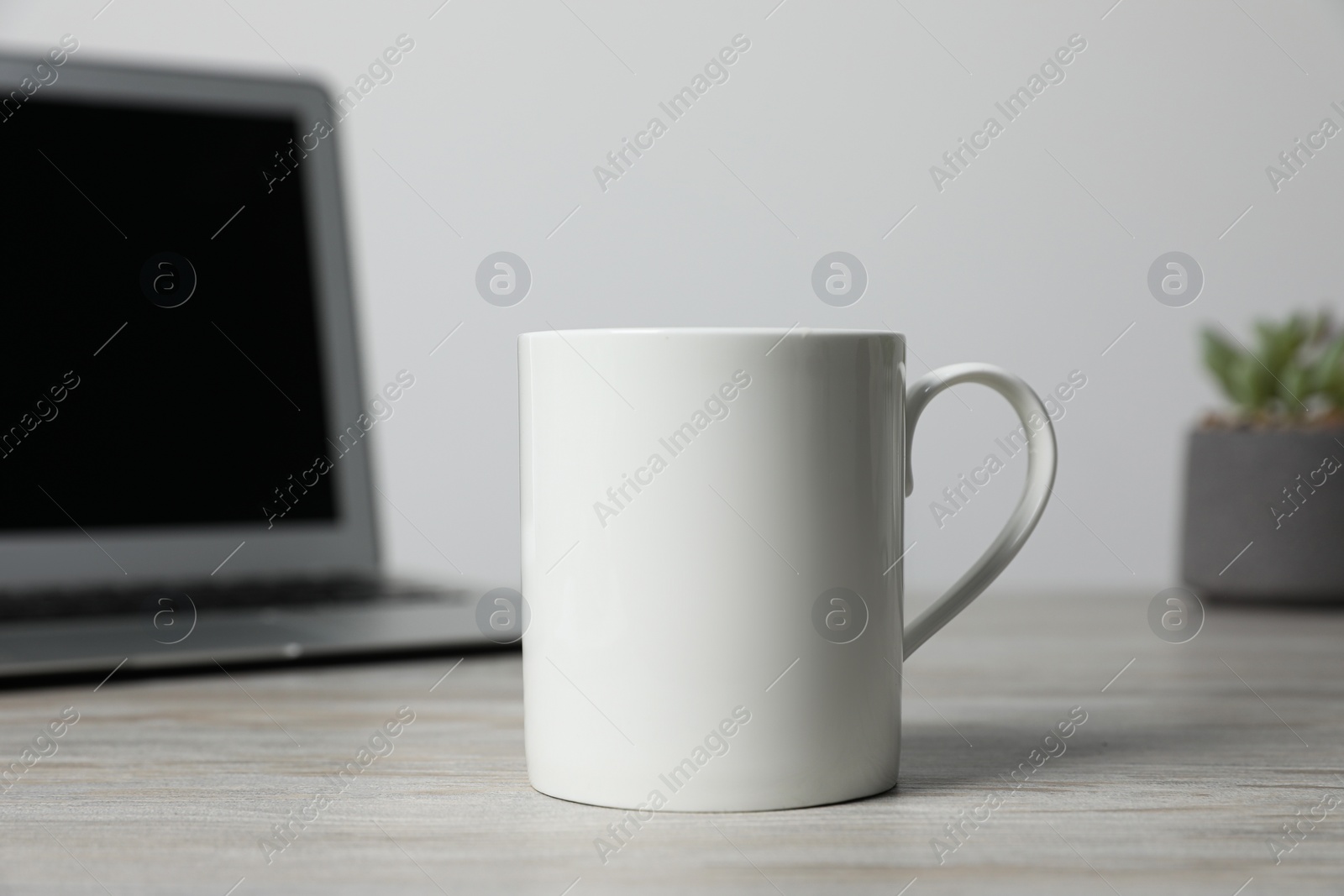 One ceramic mug on white wooden table Photo of One ceramic mug on white wooden table