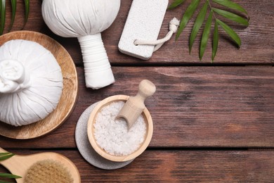 Photo of Flat lay composition with spa products and green leaves on wooden table. Space for text