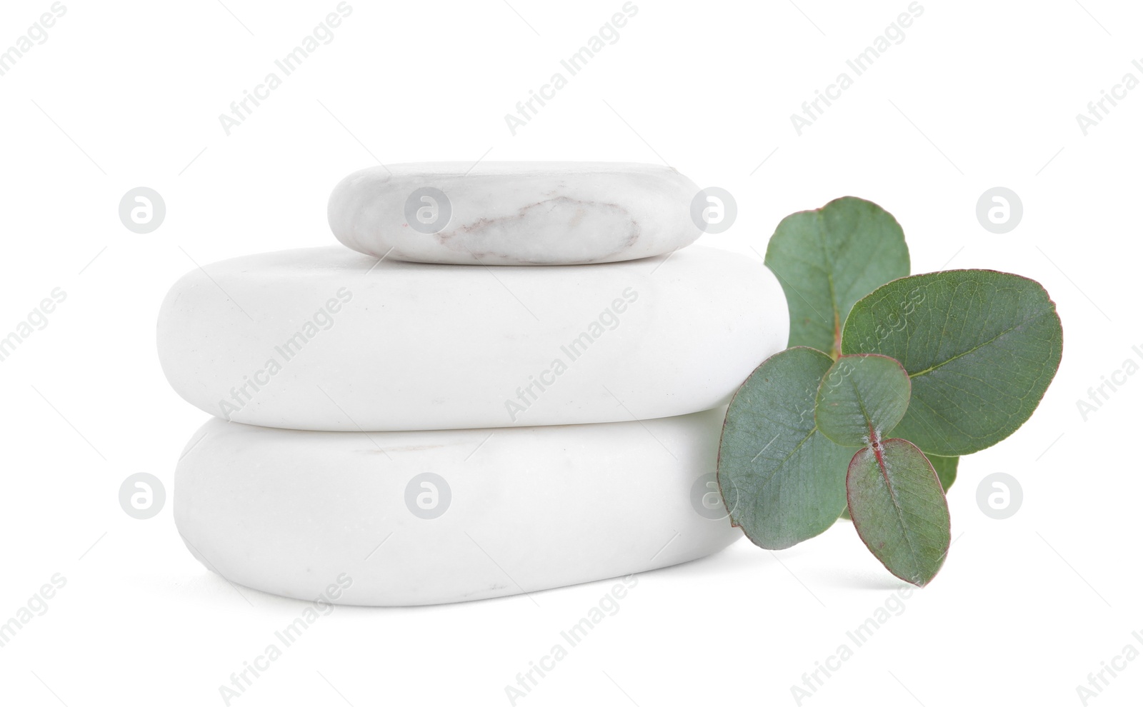 Photo of Stack of spa stones and eucalyptus isolated on white