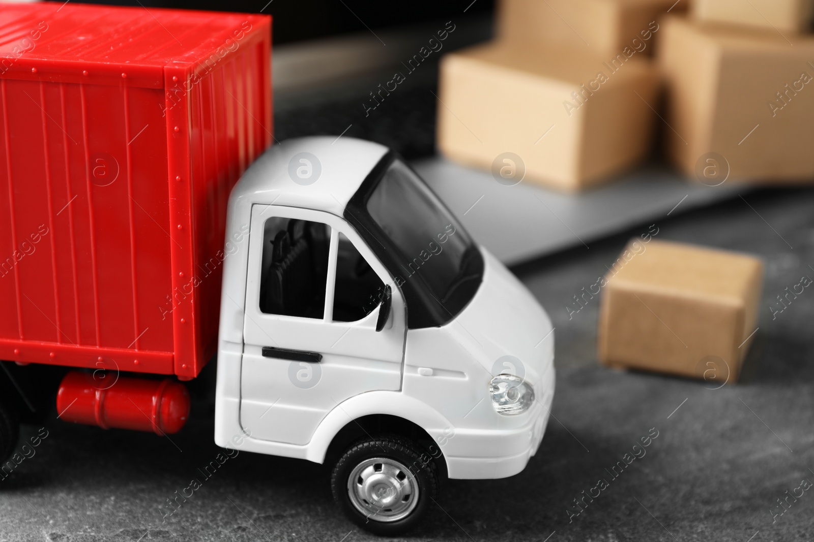 Photo of Toy truck on table. Logistics and wholesale concept