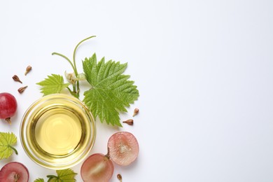 Photo of Composition with bowl of natural grape seed oil on white background, top view. Organic cosmetic