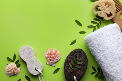 Flat lay composition with pumice stones on light green background