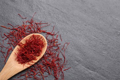 Photo of Dried saffron on grey table, flat lay. Space for text