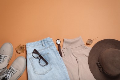 Flat lay composition with stylish hat and clothes on orange background, space for text
