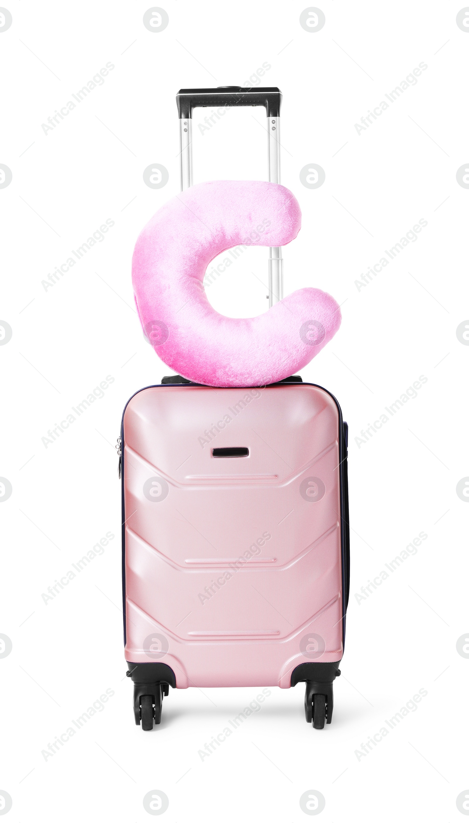 Photo of Pink travel pillow on suitcase against white background