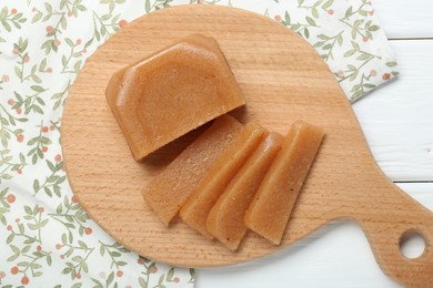 Photo of Tasty sweet quince paste on white wooden table, top view