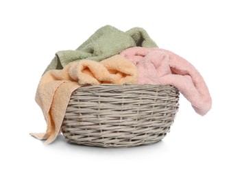 Photo of Towels in wicker basket on white background