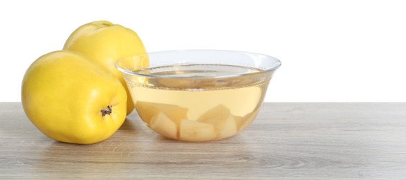 Delicious quince drink and fresh fruits on wooden table against white background